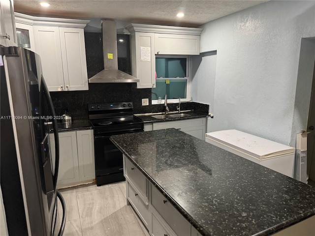 kitchen with sink, wall chimney exhaust hood, black range with electric cooktop, stainless steel fridge, and decorative backsplash