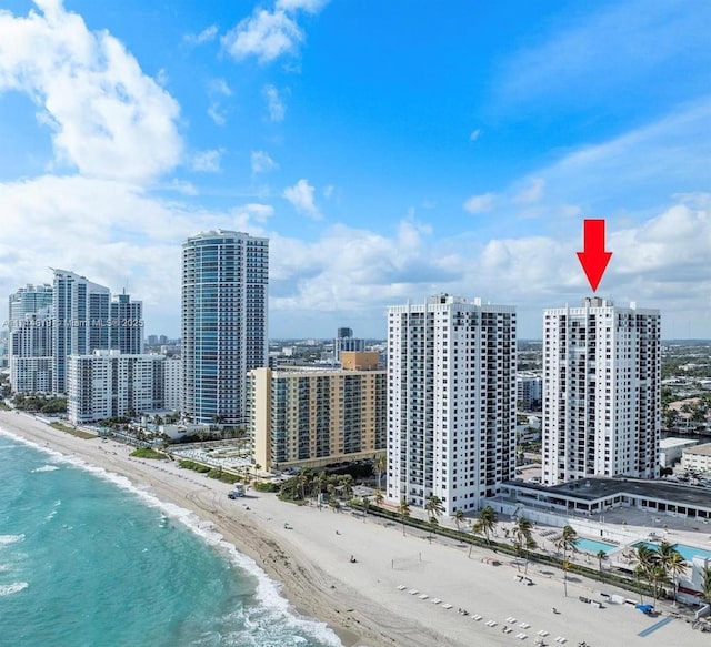 birds eye view of property with a beach view and a water view