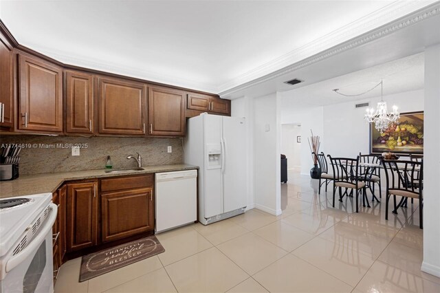 2401 S Ocean Dr Unit 1007, Hollywood, FL 33019 - kitchen featuring an inviting chandelier, white appliances, visible vents, a sink, and decorative backsplash