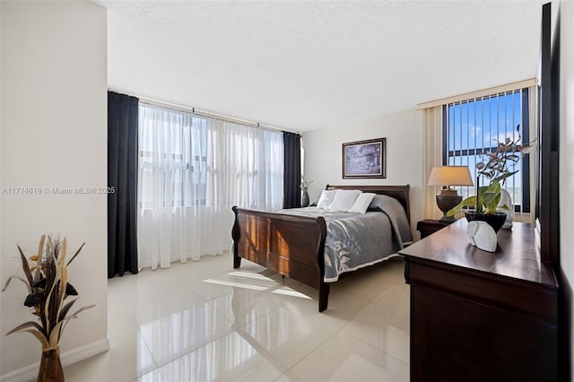 bedroom featuring light tile patterned floors and a textured ceiling