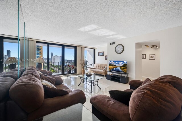 2401 S Ocean Dr Unit 1007, Hollywood, FL 33019 - living area with a textured ceiling, light tile patterned floors, a wall of windows, and visible vents