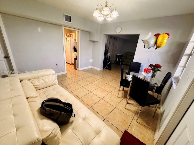 living room with light tile patterned floors and a chandelier