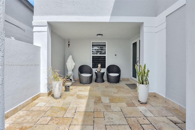 entrance to property with a patio area and stucco siding