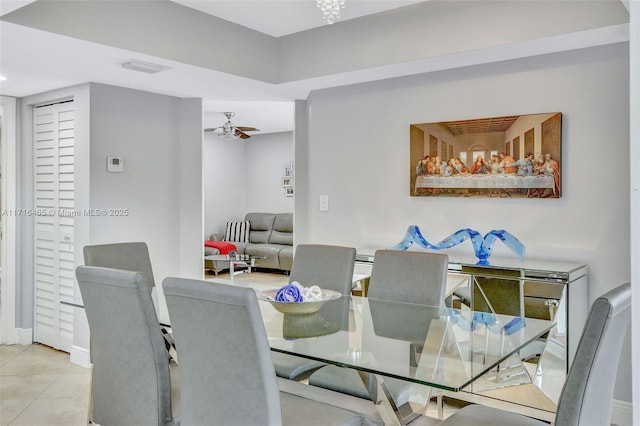 tiled dining space with visible vents and ceiling fan