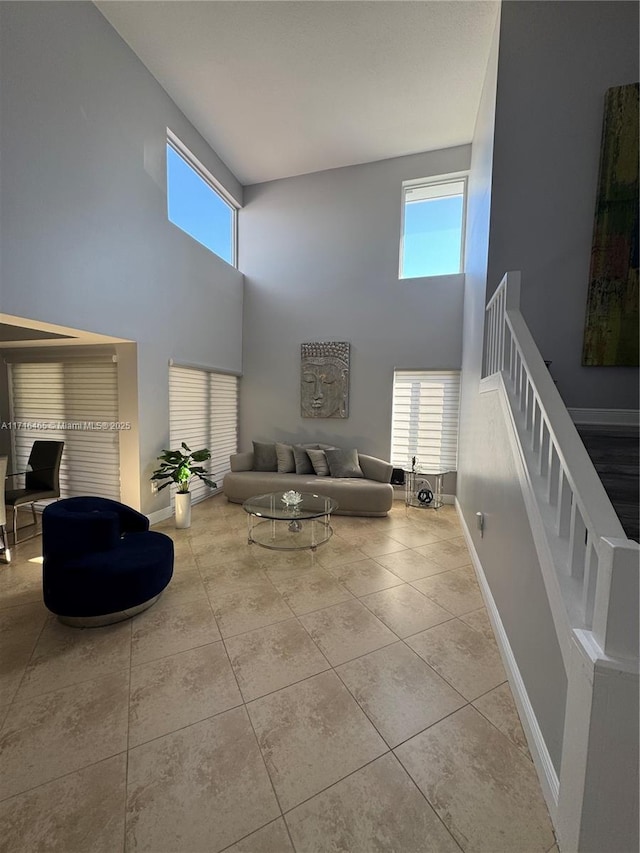 tiled living room featuring a high ceiling