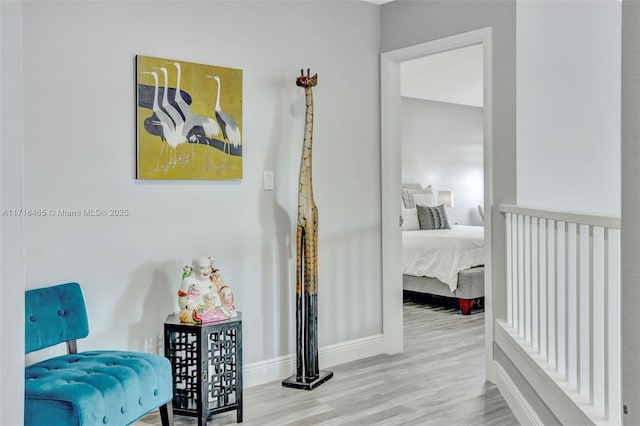 corridor featuring baseboards and wood finished floors