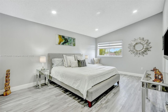 bedroom with recessed lighting, baseboards, light wood-style floors, and lofted ceiling