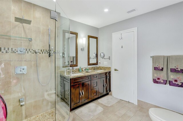 bathroom featuring vanity, an enclosed shower, tile walls, and toilet