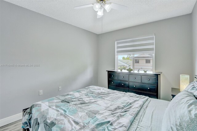 bedroom featuring dark hardwood / wood-style flooring and a textured ceiling