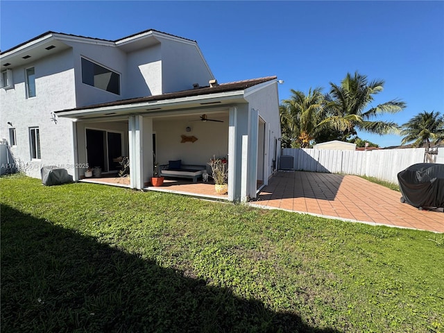 rear view of house featuring a yard and a patio area