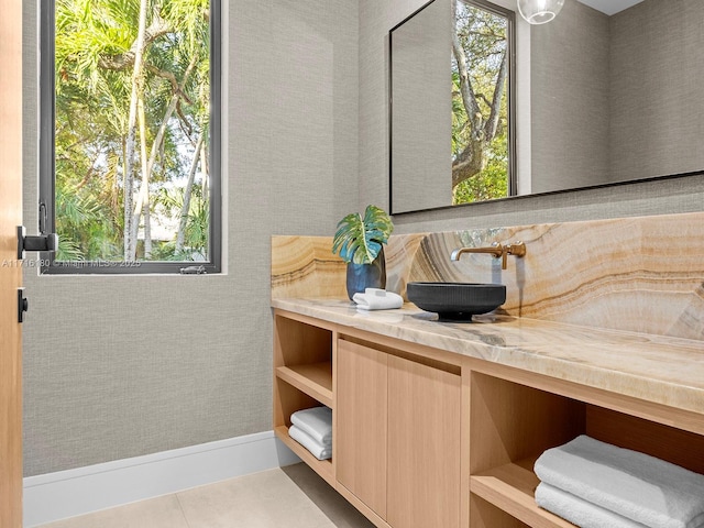 bathroom with tile patterned flooring, a healthy amount of sunlight, and vanity