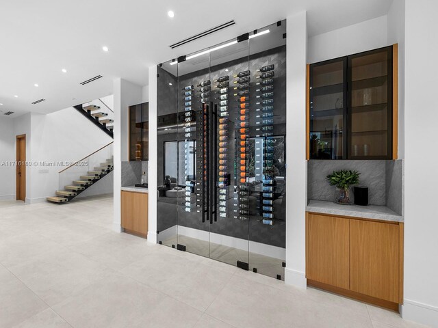 wine area featuring tile patterned floors and recessed lighting