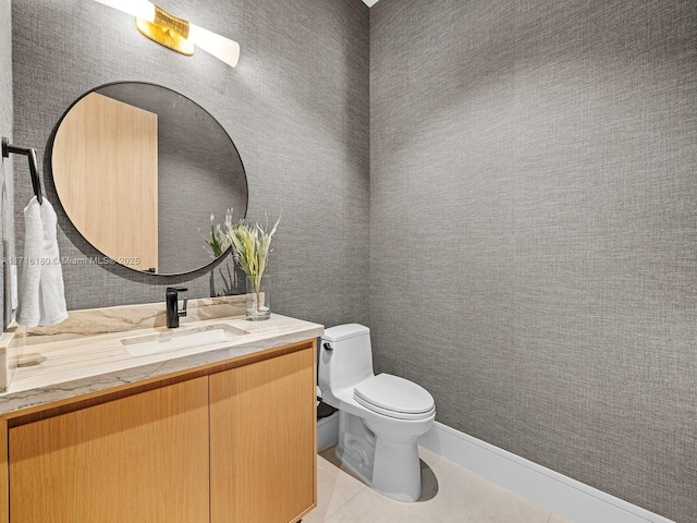 bathroom with tile patterned flooring, vanity, and toilet