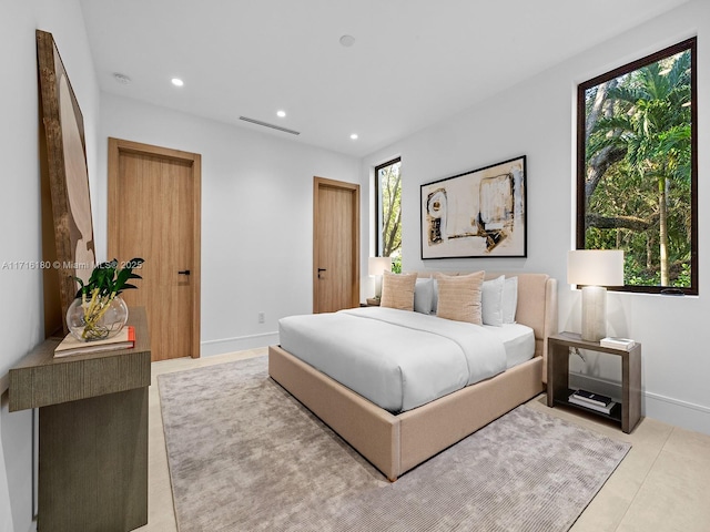 bedroom with recessed lighting, multiple windows, and baseboards