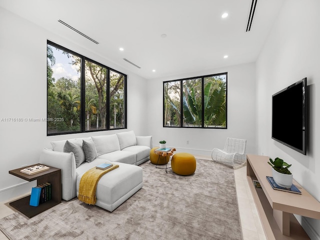 tiled living room with recessed lighting and visible vents