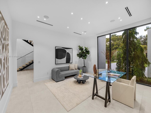 living room with light tile patterned floors, recessed lighting, visible vents, stairway, and baseboards