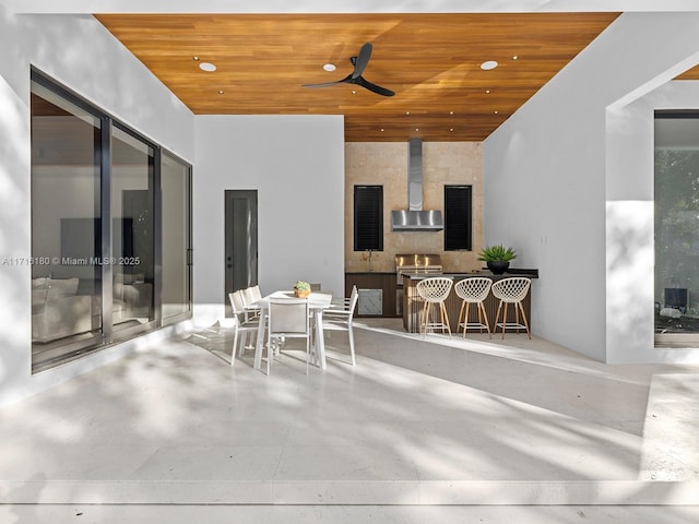 view of patio featuring area for grilling, a ceiling fan, and outdoor dining space