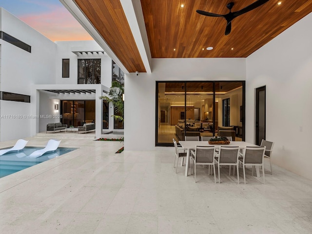 view of patio with an outdoor pool, outdoor dining area, an outdoor hangout area, and a ceiling fan