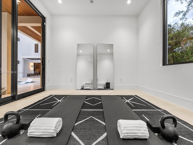 workout area featuring baseboards and recessed lighting