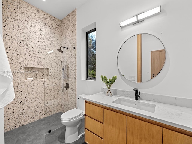 bathroom featuring walk in shower, tile patterned flooring, vanity, and toilet