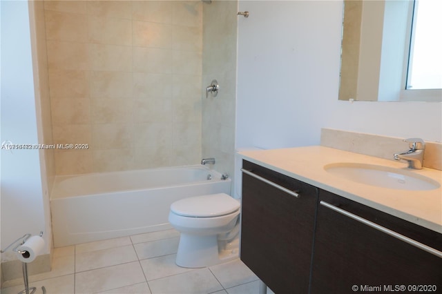 full bathroom with tile patterned flooring, vanity, tiled shower / bath combo, and toilet