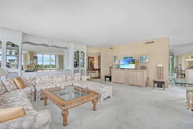 carpeted living room with a textured ceiling