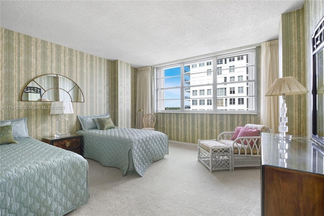 bedroom with carpet floors and a textured ceiling