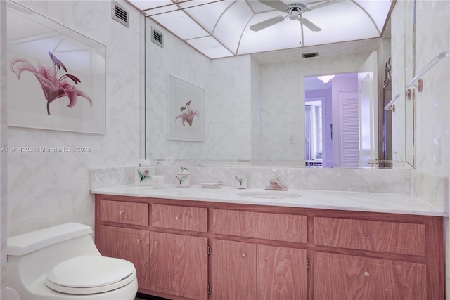 bathroom with vanity, ceiling fan, and toilet