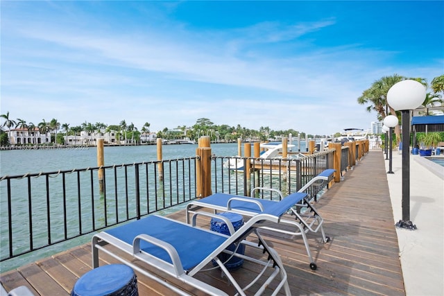 wooden deck featuring a water view and a boat dock