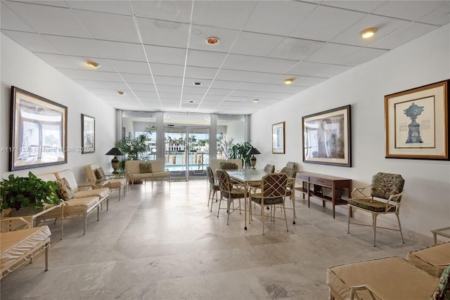 dining space with a paneled ceiling