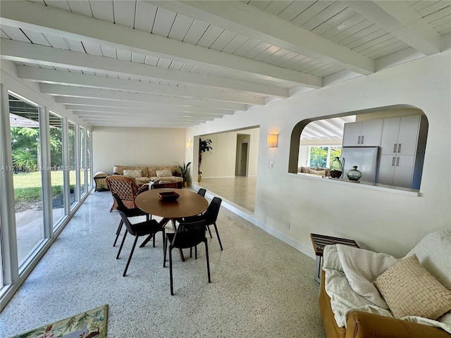 dining space featuring beamed ceiling and wooden ceiling