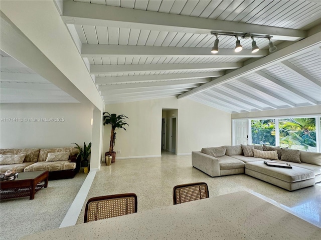 living room featuring vaulted ceiling with beams