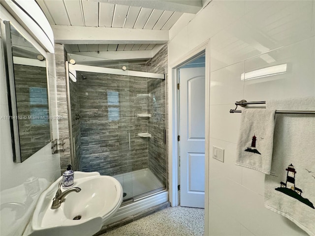 bathroom with beamed ceiling, sink, walk in shower, and wood ceiling