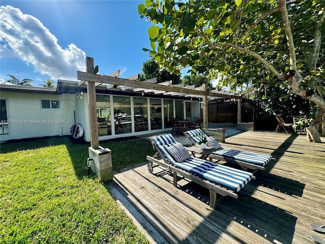 wooden terrace with a pergola and a lawn