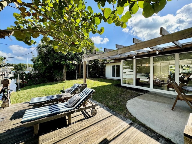 wooden terrace featuring a pergola and a lawn