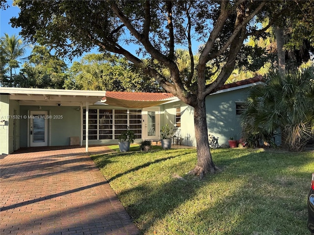 rear view of house featuring a yard