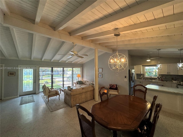 dining area featuring ceiling fan with notable chandelier, sink, and lofted ceiling with beams