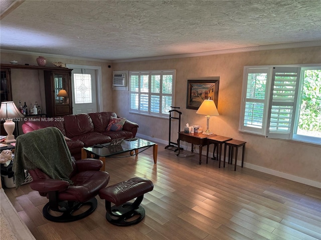 living room featuring light wood-type flooring, a textured ceiling, a wall mounted AC, and ornamental molding