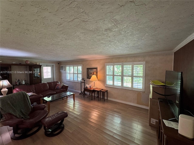 living room featuring an AC wall unit, hardwood / wood-style floors, and a textured ceiling