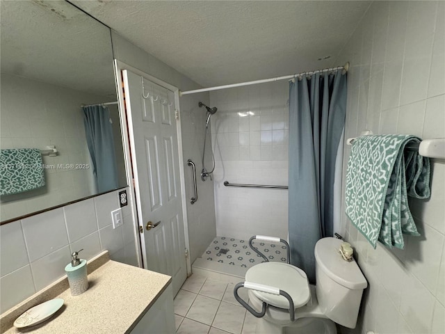 bathroom with a shower with curtain, tile patterned floors, a textured ceiling, toilet, and tile walls