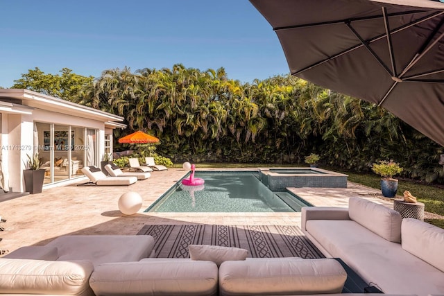 view of pool featuring an in ground hot tub, outdoor lounge area, and a patio