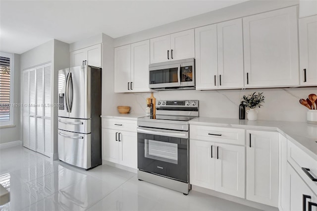 kitchen featuring appliances with stainless steel finishes and white cabinetry