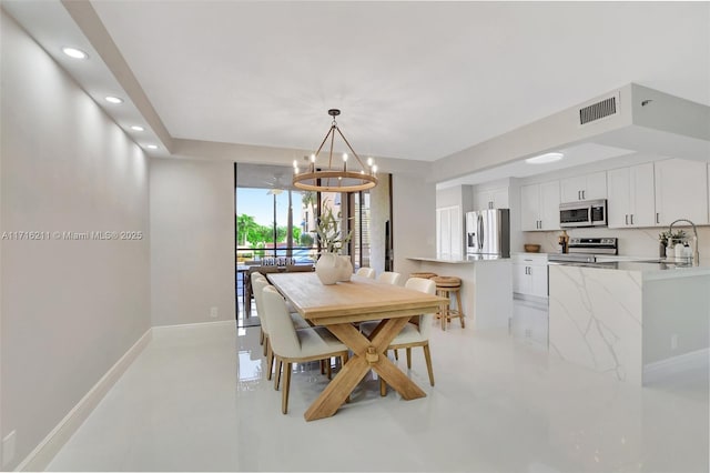 dining area with sink and an inviting chandelier