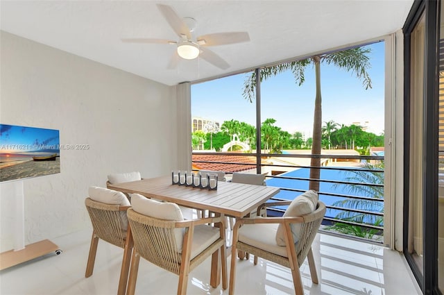 dining area with floor to ceiling windows and ceiling fan