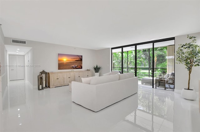 tiled living room with a wall of windows