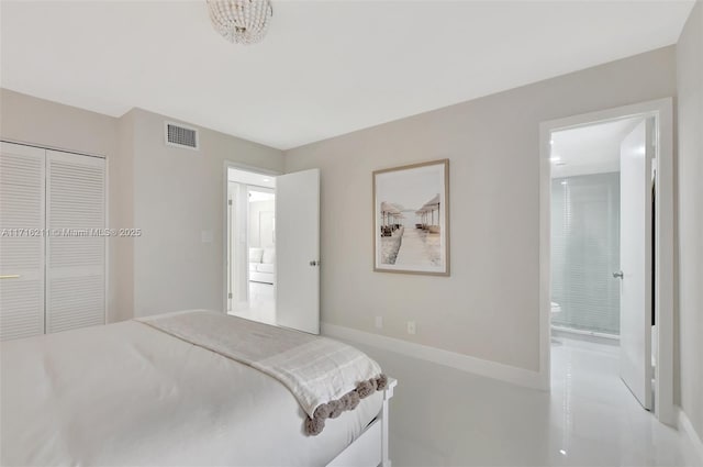 bedroom with ensuite bath and a closet