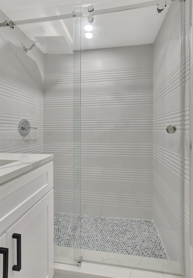 bathroom with vanity and a shower with shower door