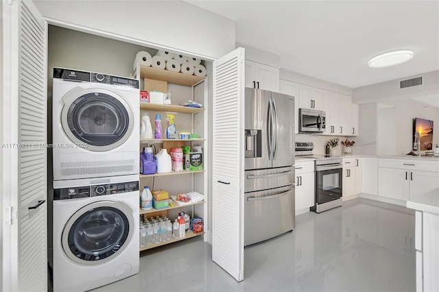 laundry area featuring stacked washing maching and dryer