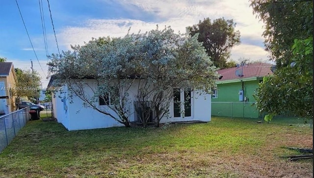 rear view of property with a lawn