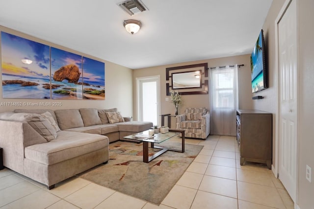 living area with light tile patterned flooring and visible vents